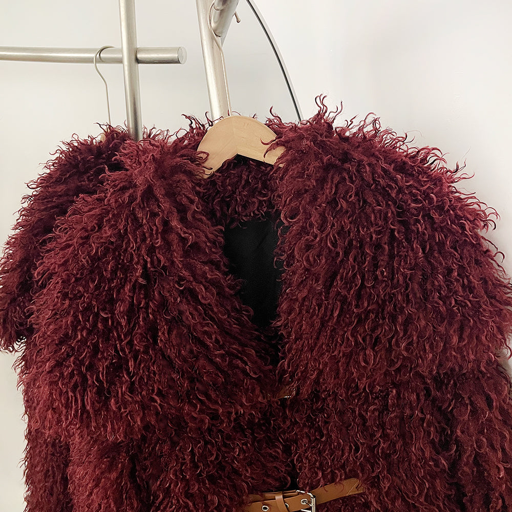 Close-up of dramatic wide oversized lapel on fluffy vegan curly fur coat