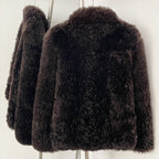 Back view of the tailored short curly wool shearling jacket in rich espresso
