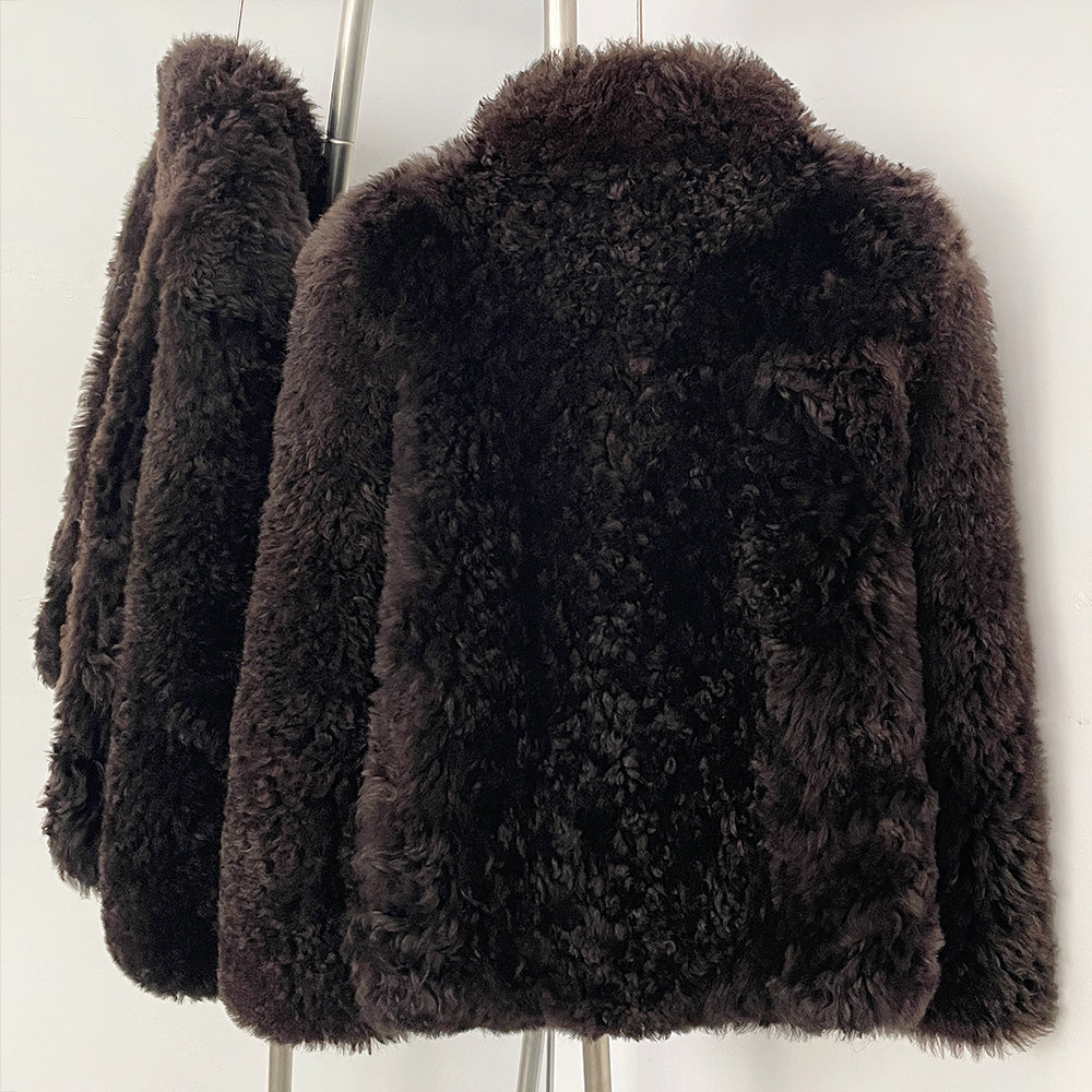 Back view of the tailored short curly wool shearling jacket in rich espresso
