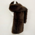 Side view of a rich coffee brown long-line faux fur gilet with voluminous shawl collar