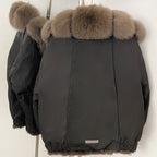 Back view of the luxury real fur parka showing the clean technical shell and fur hood