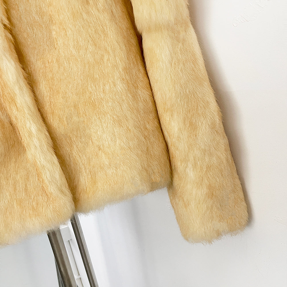 Texture shot of silky natural genuine rabbit fur sleeve hem