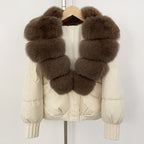 Elegant cream-colored down puffer with rich brown tiered fox fur collar