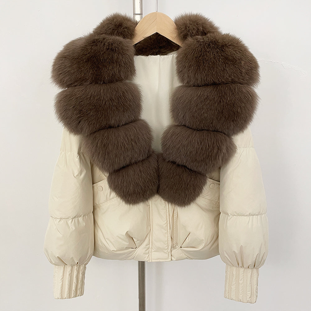 Elegant cream-colored down puffer with rich brown tiered fox fur collar