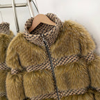 Close-up of the circular ring-pull zipper and stand-up wool collar on the panelled jacket