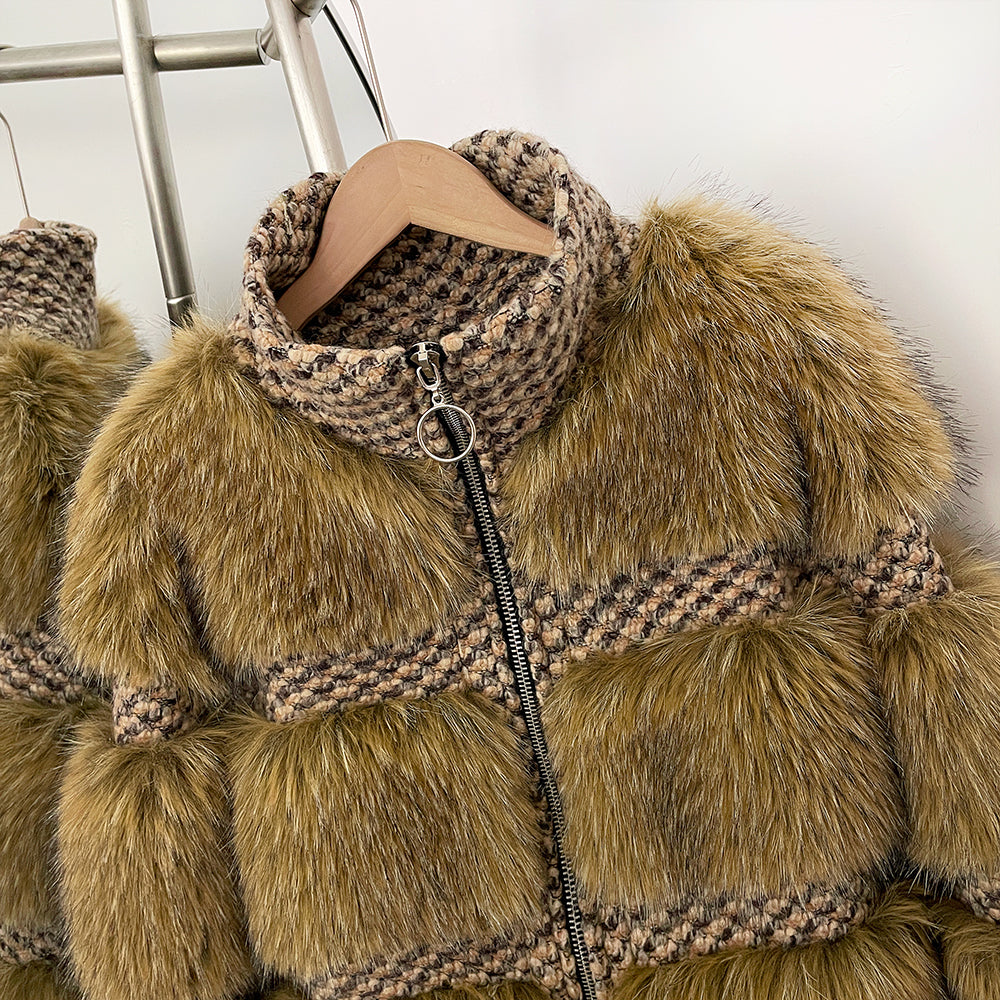 Close-up of the circular ring-pull zipper and stand-up wool collar on the panelled jacket