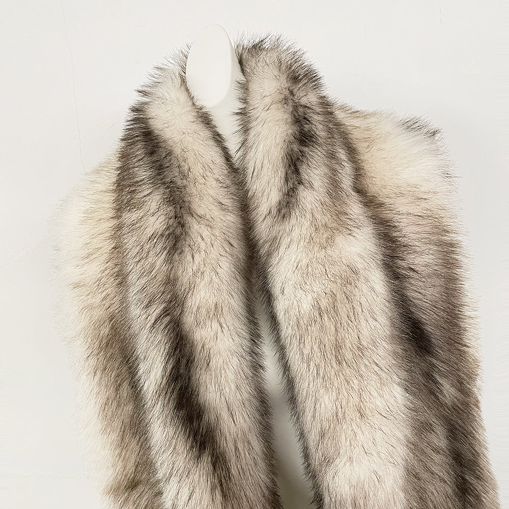 Close-up of the plush oversized shawl collar and long-line silhouette of a luxury fur vest
