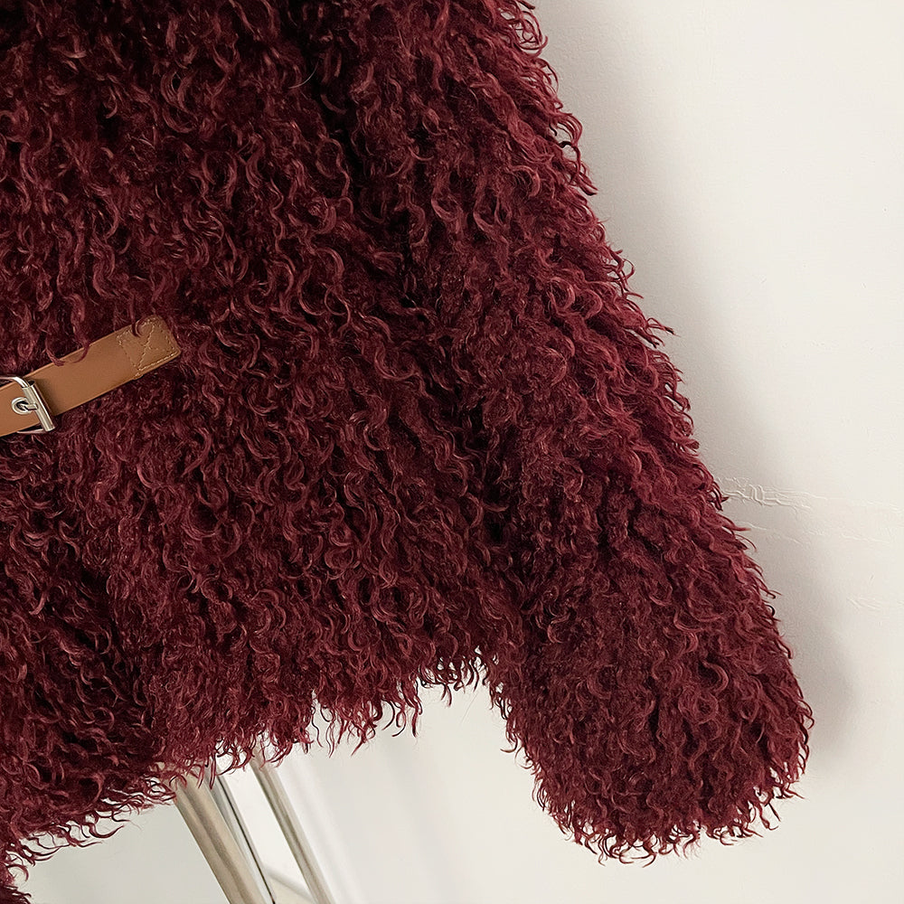 Detail shot of adjustable leather metal buckle belt on faux fur jacket