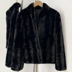 Close-up of tailored stand collar on black faux mink fur jacket
