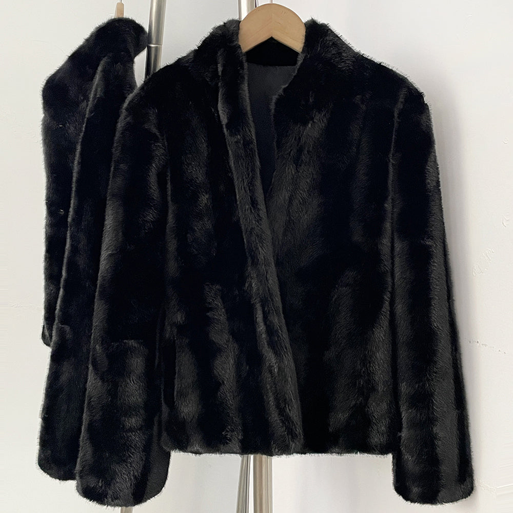 Close-up of tailored stand collar on black faux mink fur jacket