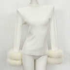 Front view of white ribbed knit mock neck top with matching white fox fur cuffs